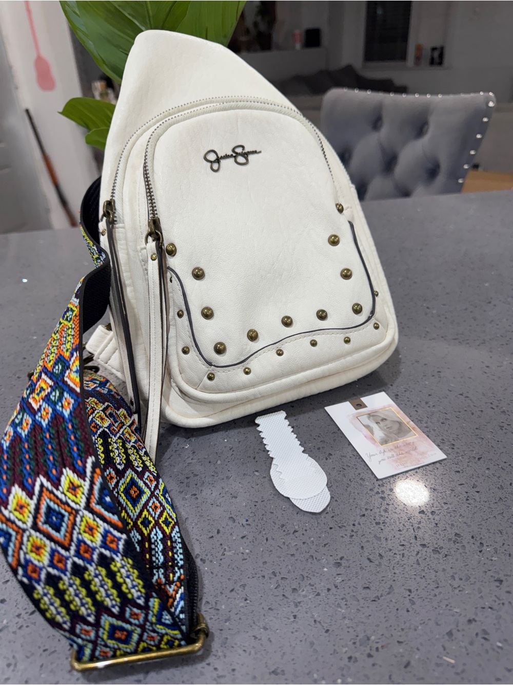 Jessica Simpson White Studded Sling Backpack with Multicolor Woven Strap